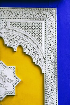 Close-up of colorful Moroccan architectural design with intricate patterns and vibrant hues.